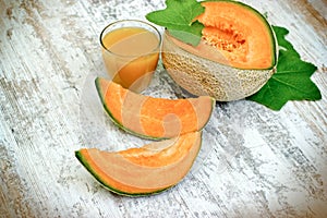 Tasty and juicy melon - cantaloupe and melon juice smoothie on rustic table