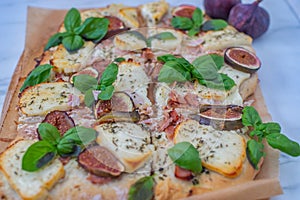 Tasty juicy pizza with figs on wooden background