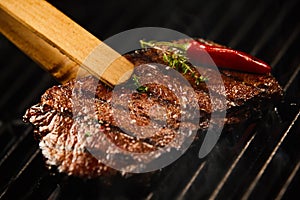 Tasty lean rump steak sizzling on a BBQ fire