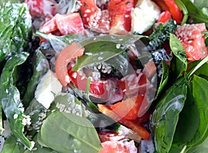 Tasty lettuceas background. Light vegetarian salad from raw fresh vegetables with greens and yogurt top view closeup