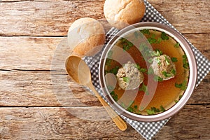 Tasty Liver dumplings added to broth make a wonderful authentic German soup close-up in a plate. horizontal top view