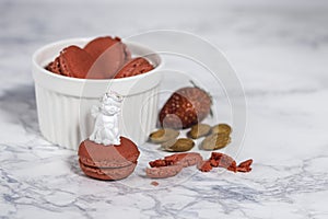Tasty macarons in a stylish bowl on white marble background. Minimalist concept of style and french chic and selective