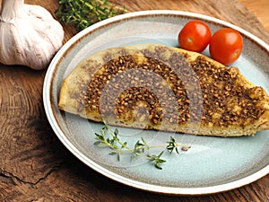 Tasty manaqish with thyme and sesame