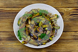 Tasty marrows in soy sauce on wooden table. Top view