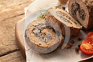 Tasty Meatloaf with mushrooms on wooden table