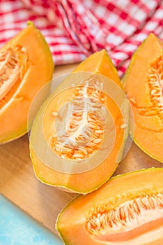 Tasty melon pieces on rustic table