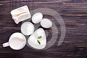 Tasty milk products with eggs on wooden table