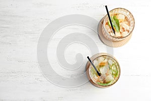 Glasses with mint julep cocktail on light background, top view photo