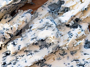 Tasty moldy cheese texture background. Blue mold cheese close up photo