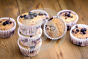 Tasty Muffin Cupcakes with Blueberries on a Wooden Background Pile of Homemade Muffins Horizontal