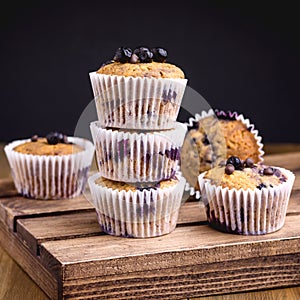 Tasty Muffin Cupcakes with Blueberries on a Wooden Background Pile of Homemade Muffins Horizontal