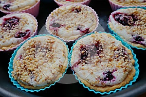 Tasty muffins with cream, berries and a nut crumb