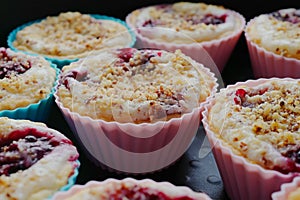 Tasty muffins with cream, berries and a nut crumb