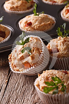 Tasty muffins with ham and cheese close-up. vertical