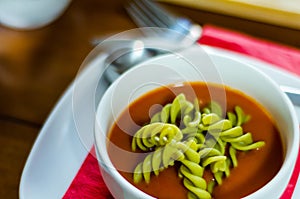 Tasty and nutritious tomato soup with fresh pasta, dietary meal