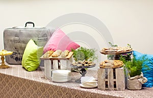 Tasty oatmeal cookies with sesame seeds on wooden boards at decorated table.