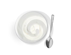 Tasty organic yogurt in bowl and spoon isolated on white