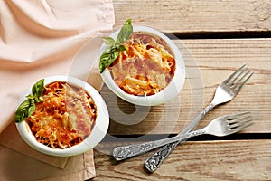 Tasty pasta Al Forno in ceramic bowls photo
