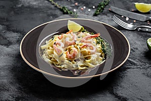 Tasty pasta with shrimps, Italian pasta fettuccine with grilled shrimps, bechamel sauce and thyme, banner, menu recipe place for