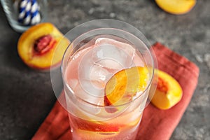 Tasty peach cocktail in glass on table