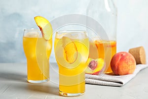 Tasty peach cocktail in glasses on table