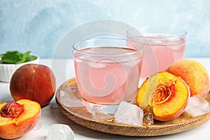 Tasty peach cocktail in glasses on table