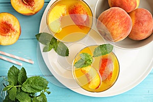 Tasty peach cocktail in glasses on table