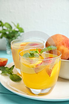 Tasty peach cocktail in glasses on table