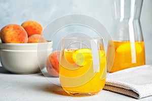 Tasty peach cocktail on table