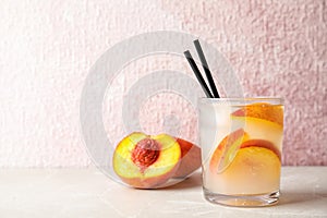 Tasty peach cocktail on table.