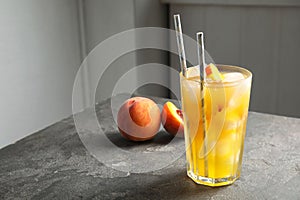 Tasty peach cocktail on table