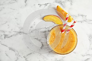 Tasty peach smoothie in glass and fresh fruit