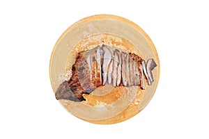 Tasty piece of slice grilled pork on circle cutting board isolated on white background, thai style food