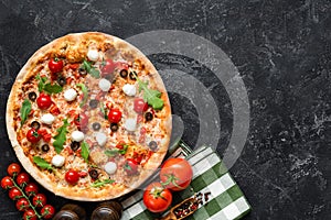 Tasty pizza on black concrete background, top view