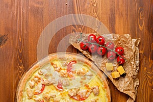 Tasty pizza with chicken and tomato