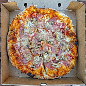 Tasty pizza in paper box