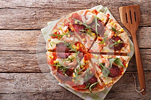 Tasty pizza with salami, shrimp, mozzarella and arugula. horizon