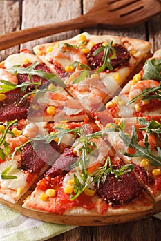 Tasty pizza with salami, shrimp, mozzarella and arugula. vertica