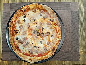 A tasty pizza served in a plate. photo