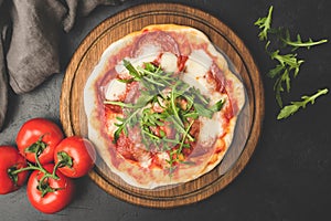 Tasty Pizza With Tomato Mozzarella Salami On Wooden Board