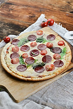 Tasty Pizza With Tomato Sauce, Pepperoni Sausage, And Mushrooms On Wooden Background Natural Rustic, A Pizza Cutter And Ingridient