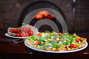 Tasty pizza in a traditional italian restaurant with a fire stone stove.