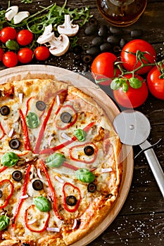 Tasty pizza on wooden table top view