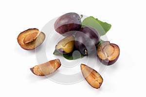 Tasty plums. Fresh plum fruits isolated on bright background, sliced and whole.