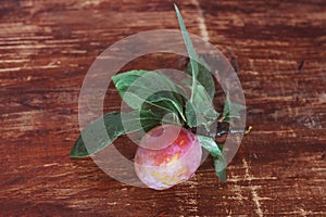 Tasty plums on wooden background