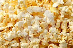 Tasty popcorn on whole background Food for watching cinema