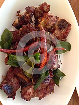 Tasty pork barbeque with kaffir leaves and chilli pepp