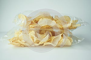 tasty potato chips in a packet on white background