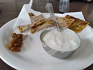 Tasty potato Parathas with curd and tea