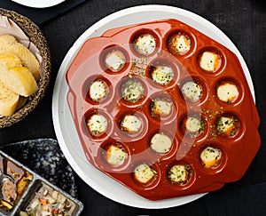 Tasty provolone cheese in molds. Served with bread and pickled vegetables. Uruguayan cuisine